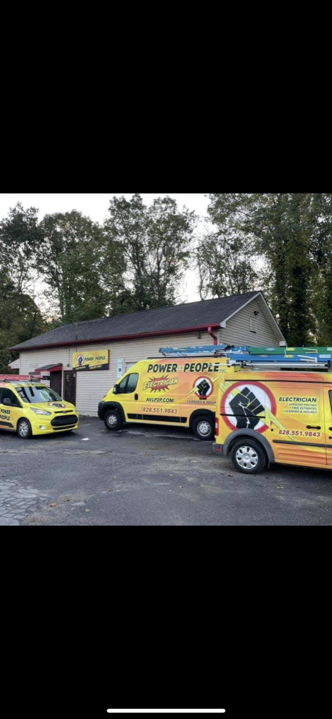Power to the People's shop on Virginia Ave in West Asheville with two of the brightly painted yellow company vans parked outside